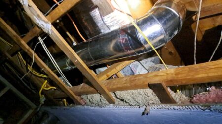 Galvanized HVAC supply duct installed in the attic as part of a residential duct system upgrade
