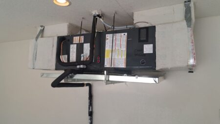 Horizontal air handler installed with insulated supply and return ductwork for residential HVAC system
