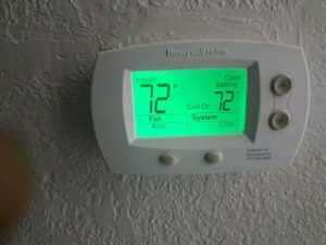 Honeywell programmable thermostat displaying cooling mode and indoor temperature settings