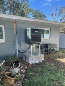 Goodman outdoor air conditioning condenser installed on an elevated stand for improved flood protection