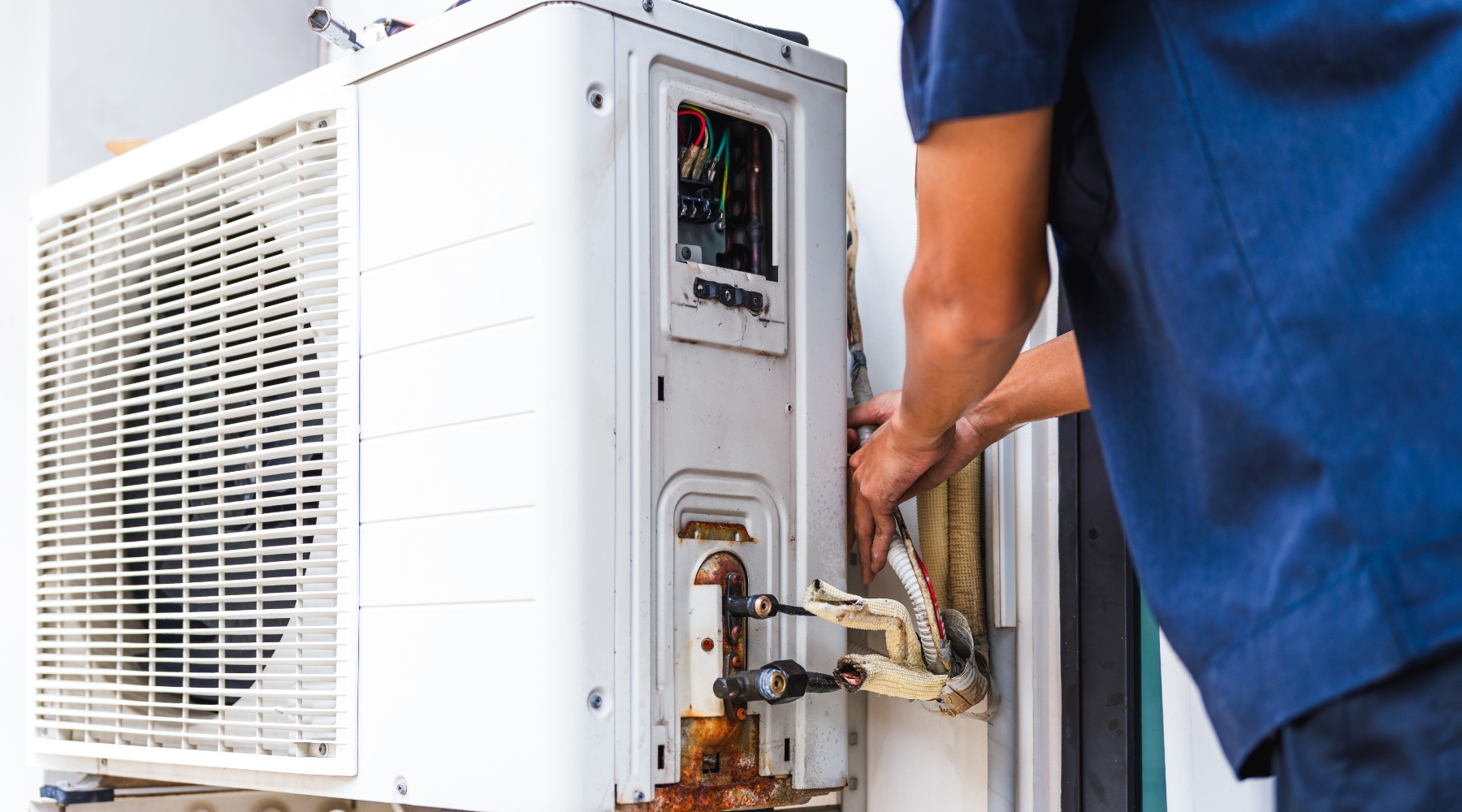 HVAC technician cleaning condensate drain